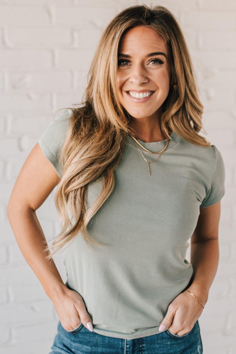 Blonde woman wearing a basic slim fit ribbed tee shirt.