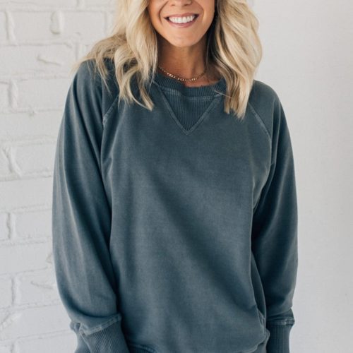 Woman wearing ribbed time sweatshirt with side pockets.