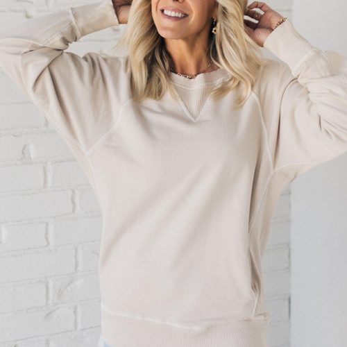 Woman wearing ribbed time sweatshirt with side pockets.