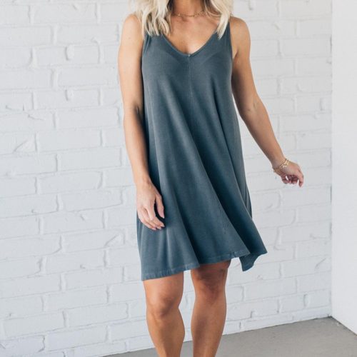 Blonde woman wearing a knee length ribbed kit dress.