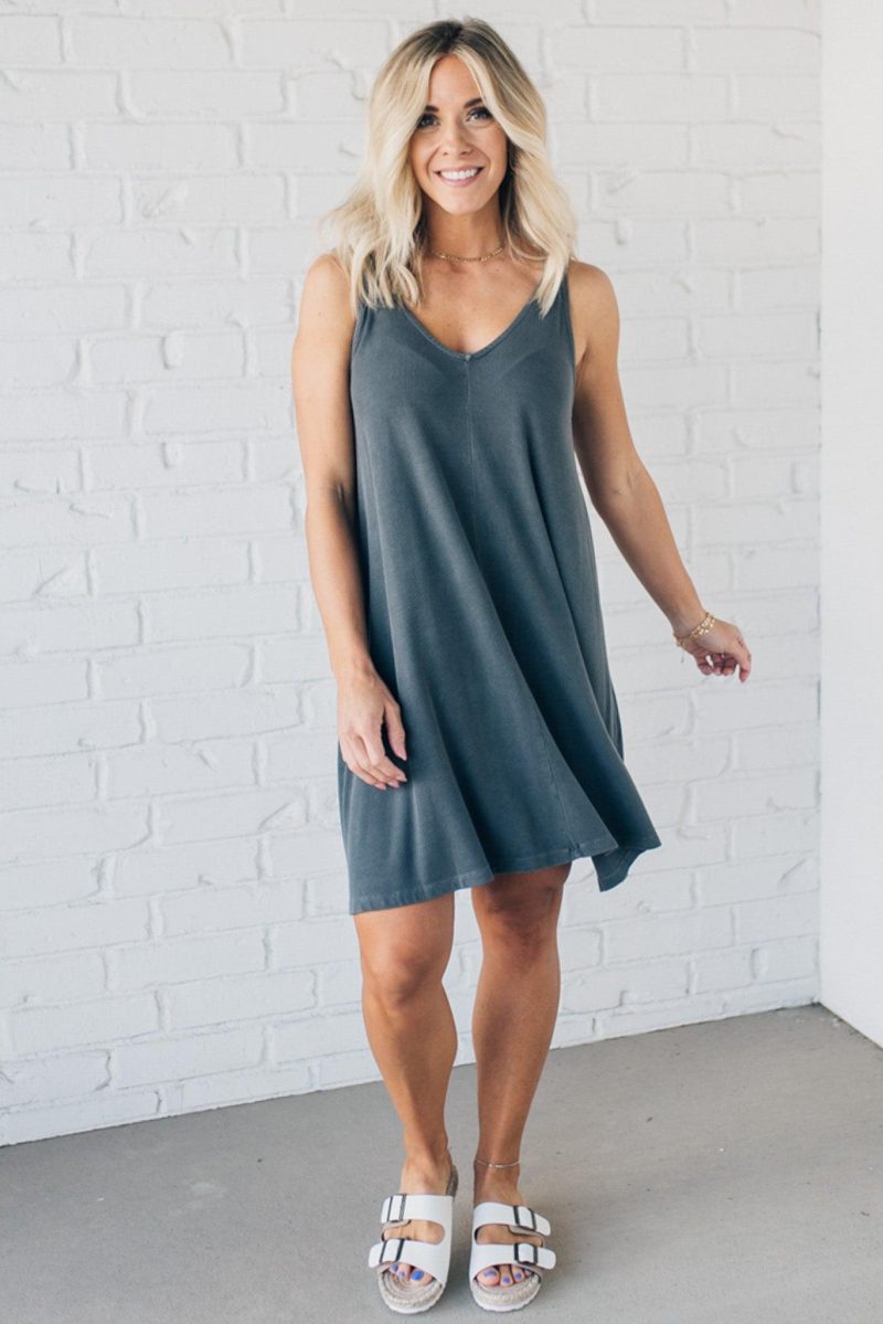 Blonde woman wearing a knee length ribbed kit dress.