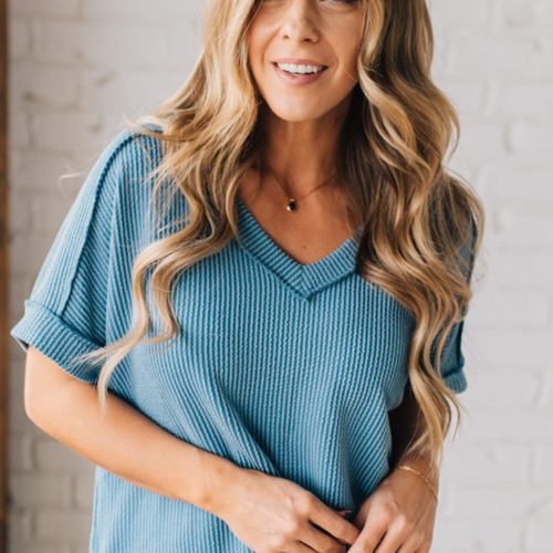 women modeling a dusty blue short sleeve corded v neck top